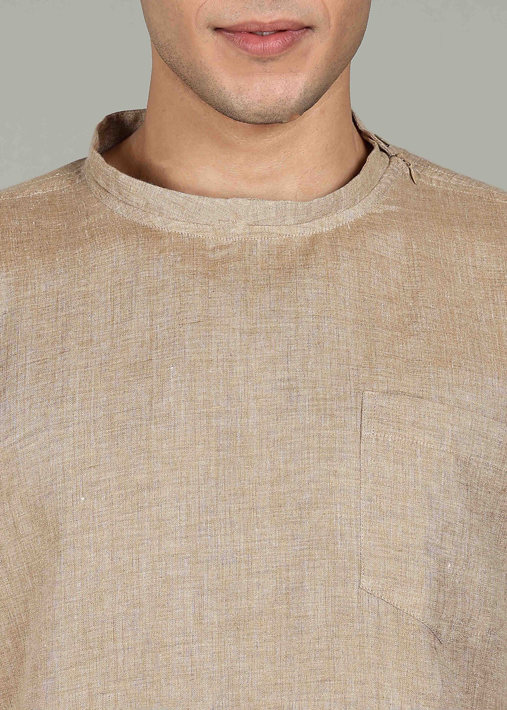 Man wearing 100% 60 LEA Mocha Mandarin collar  T - Shirt in an indoor grey background.