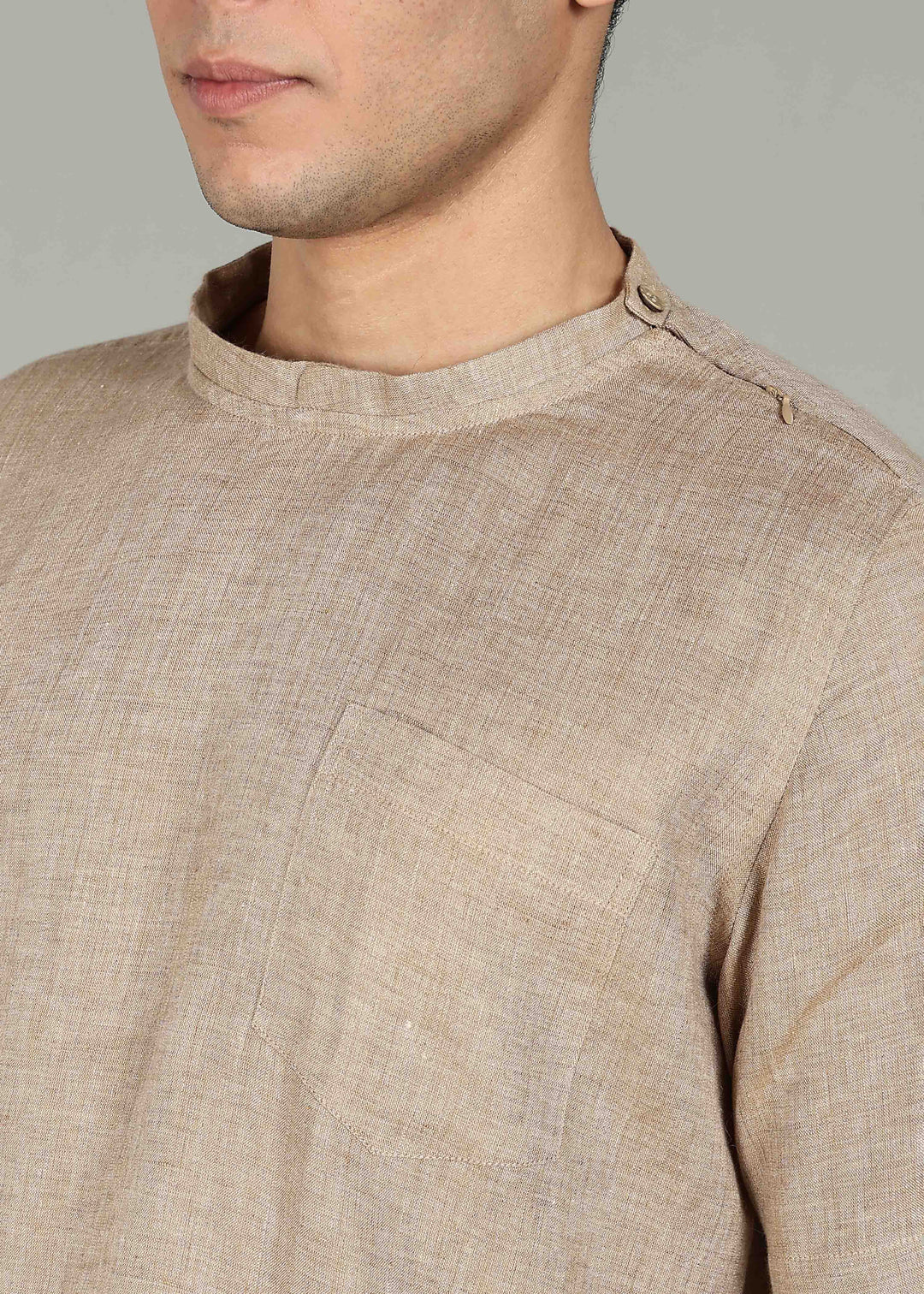 Man wearing 100% 60 LEA Mocha Mandarin collar  T - Shirt in an indoor grey background.
