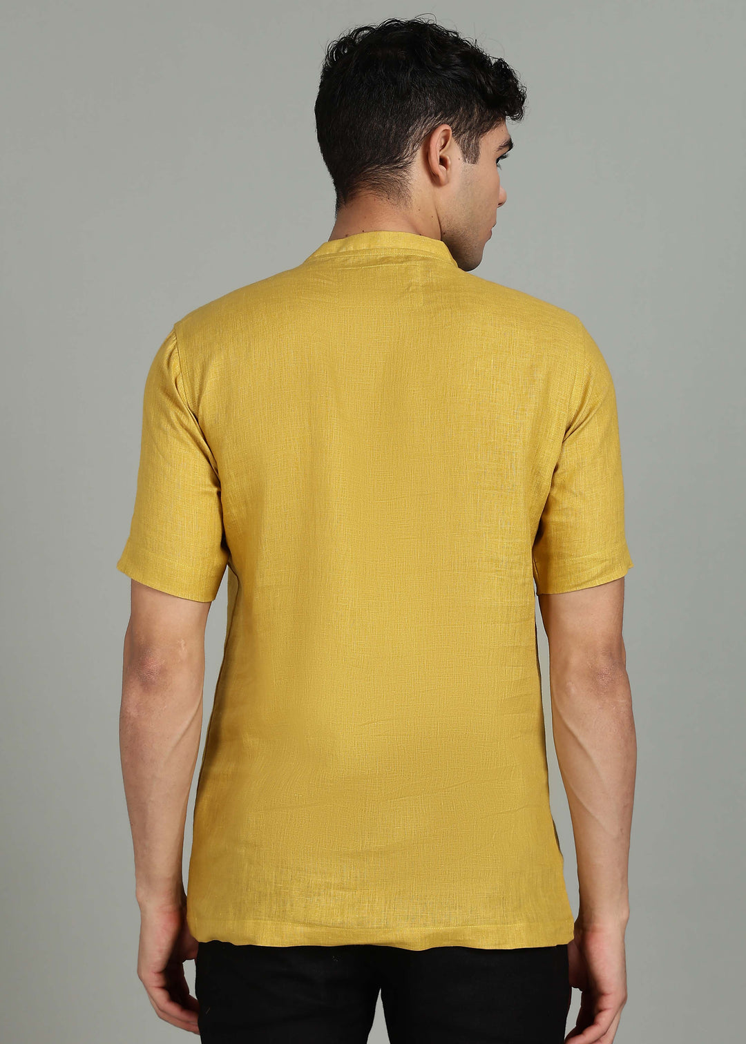 Man wearing 100% 60 LEA Sun Burst Yellow Mandarin collar  T - Shirt in an indoor grey background.