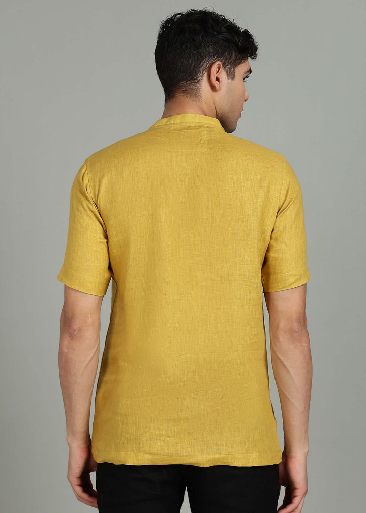 Man wearing 100% 60 LEA Sun Burst Yellow Mandarin collar  T - Shirt in an indoor grey background.
