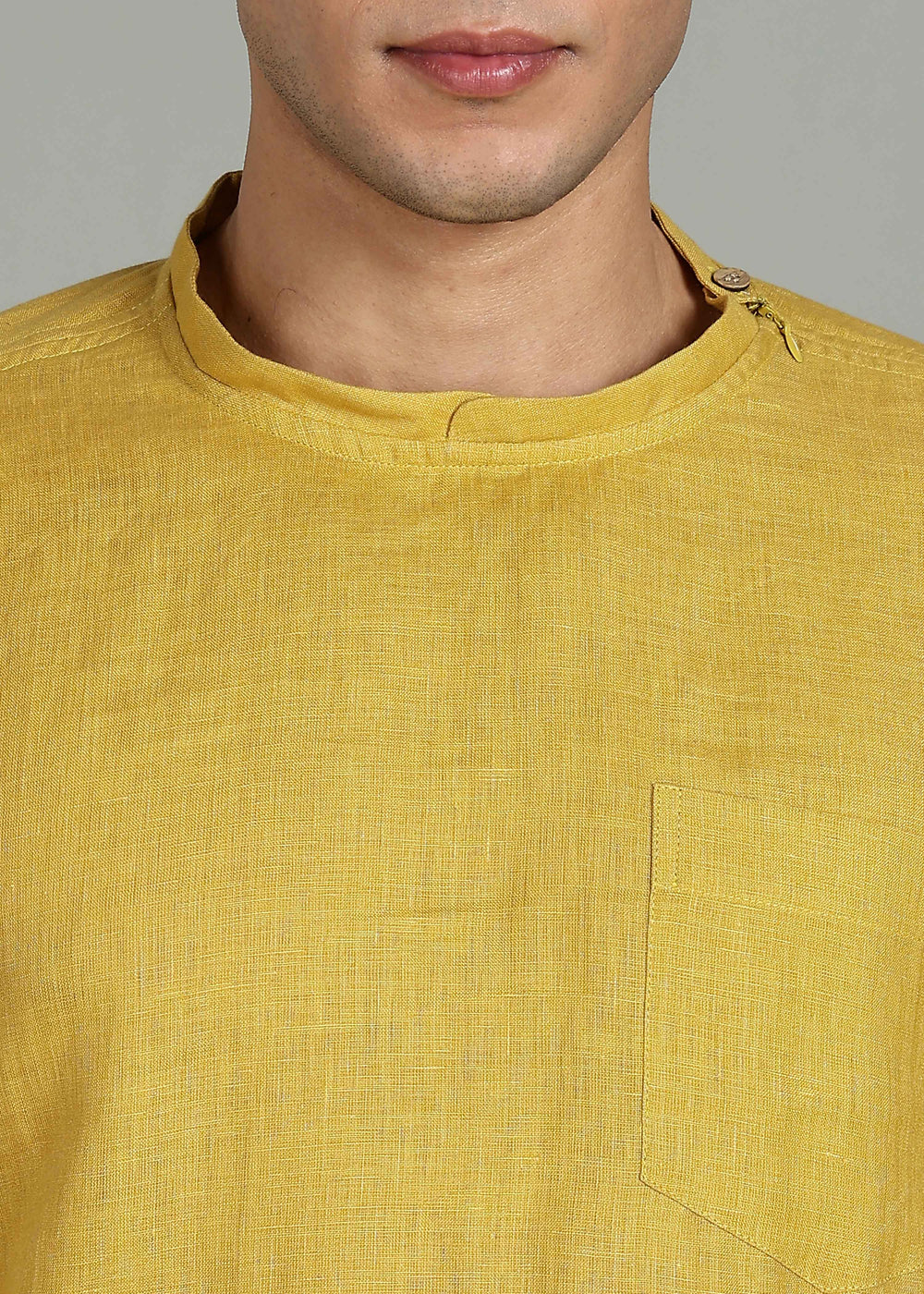 Man wearing 100% 60 LEA Sun Burst Yellow Mandarin collar  T - Shirt in an indoor grey background.