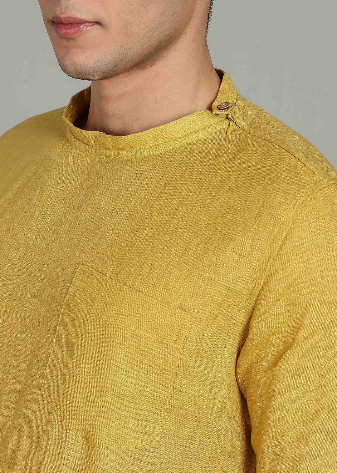 Man wearing 100% 60 LEA Sun Burst Yellow Mandarin collar  T - Shirt in an indoor grey background.