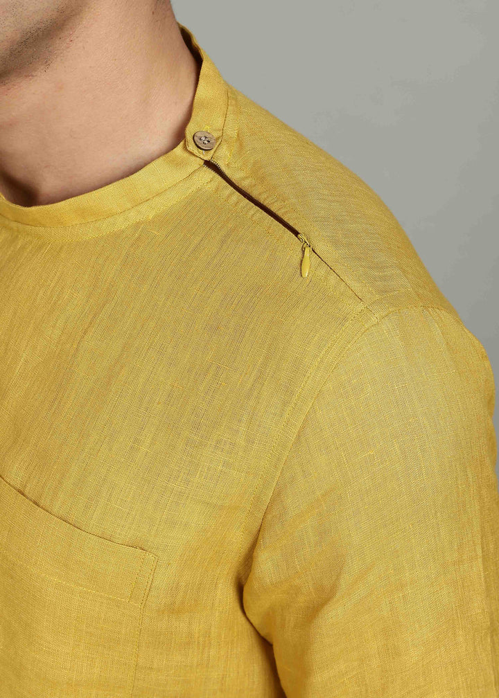 Man wearing 100% 60 LEA Sun Burst Yellow Mandarin collar  T - Shirt in an indoor grey background.