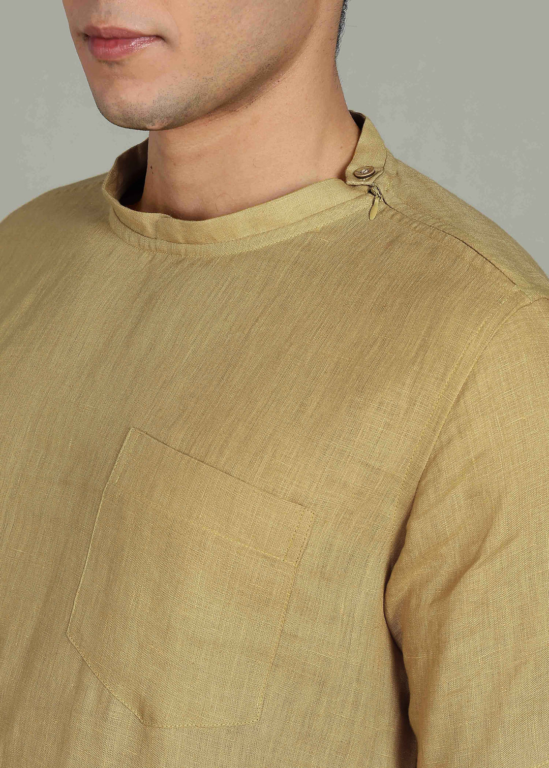 Man wearing 100% 60 LEA Sun Burst Yellow Mandarin collar  T - Shirt in an indoor grey background.