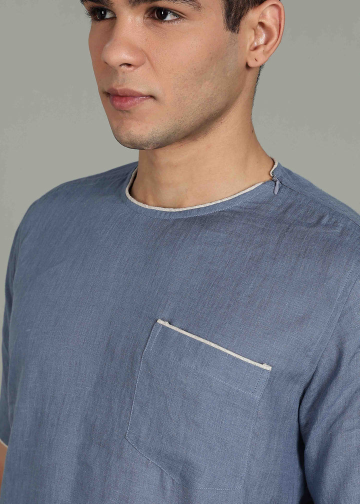 Man wearing 100% Linen Blue Grey T - Shirt in an indoor grey background