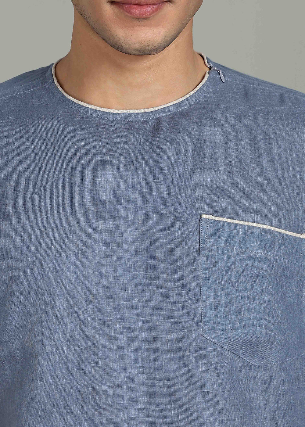 Man wearing 100% Linen Blue Grey T - Shirt in an indoor grey background