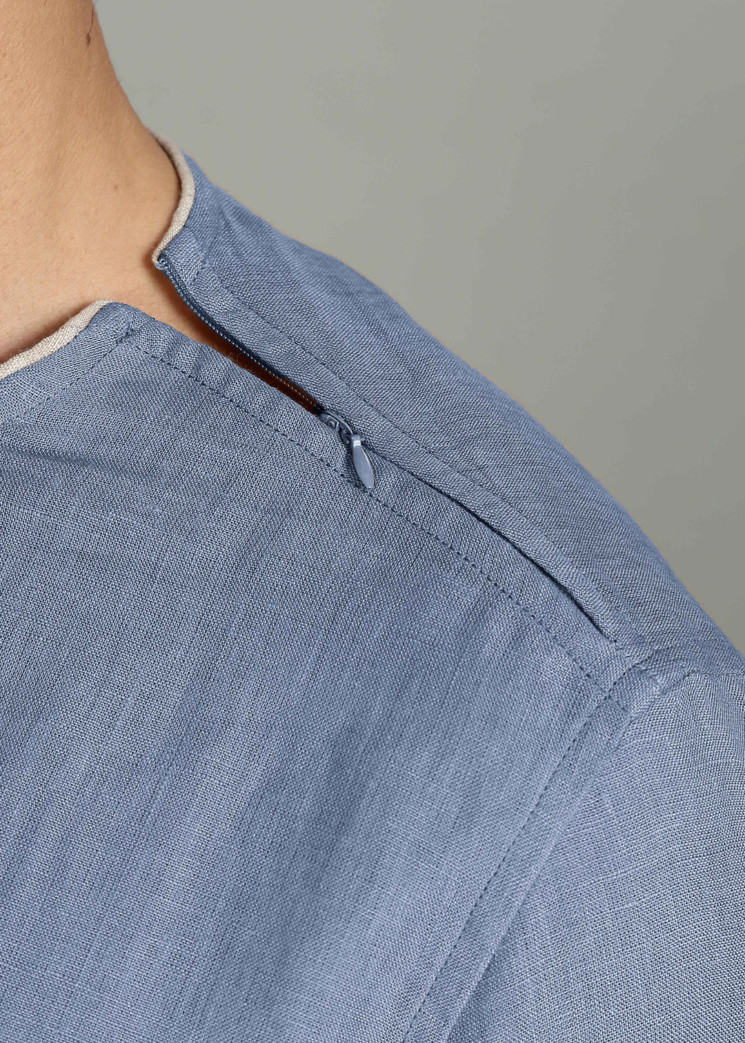 Man wearing 100% Linen Blue Grey T - Shirt in an indoor grey background