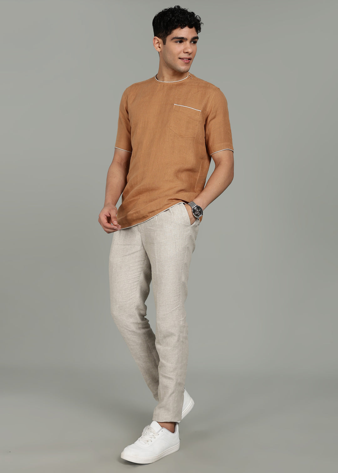 Man wearing 100% Linen Mustard Brown T - Shirt in an indoor grey background