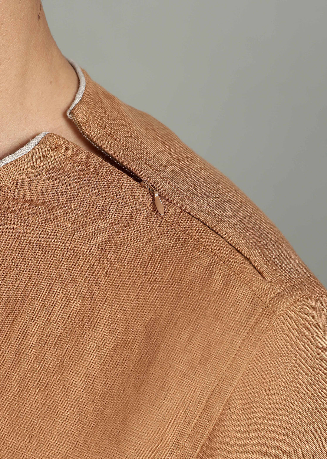 Man wearing 100% Linen Mustard Brown T - Shirt in an indoor grey background