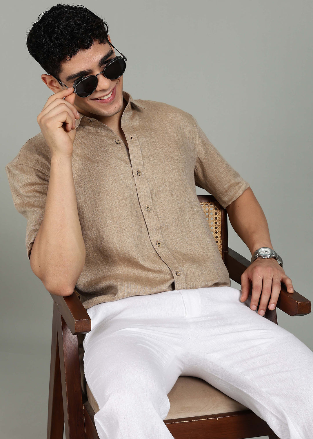 Man wearing 100% 60 LEA Mocha Half sleeve Shirt in an indoor grey background.