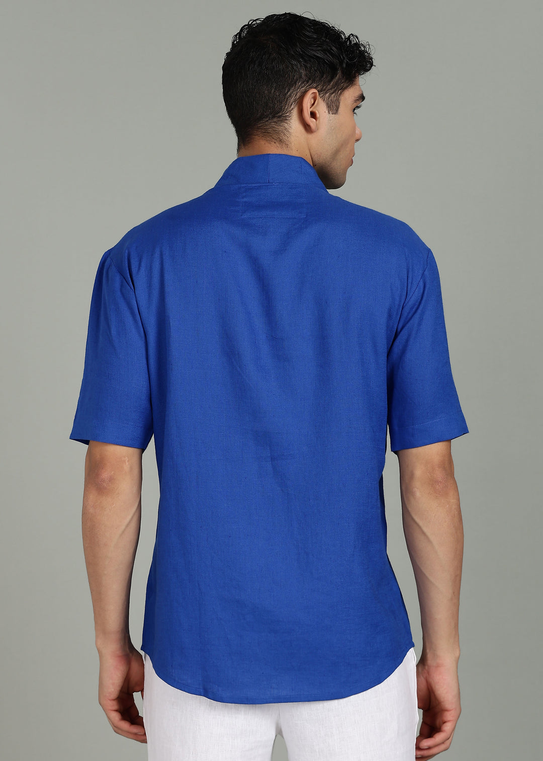 Man wearing 100% 60 LEA Egyptian Blue Shawl collar Half sleeve Shirt in an indoor grey background.