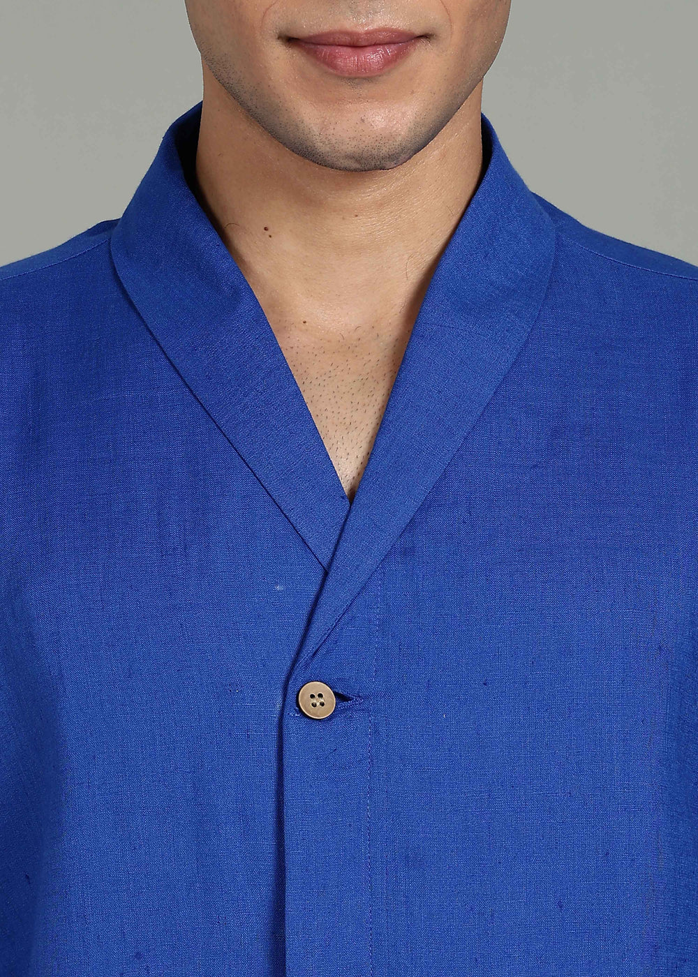 Man wearing 100% 60 LEA Egyptian Blue Shawl collar Half sleeve Shirt in an indoor grey background.