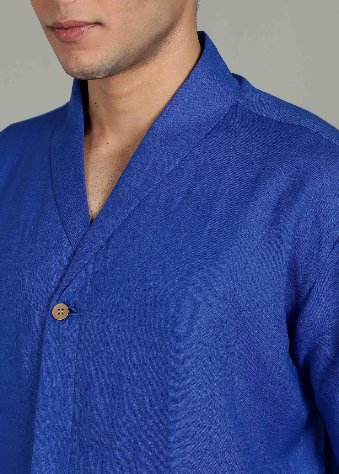 Man wearing 100% 60 LEA Egyptian Blue Shawl collar Half sleeve Shirt in an indoor grey background.