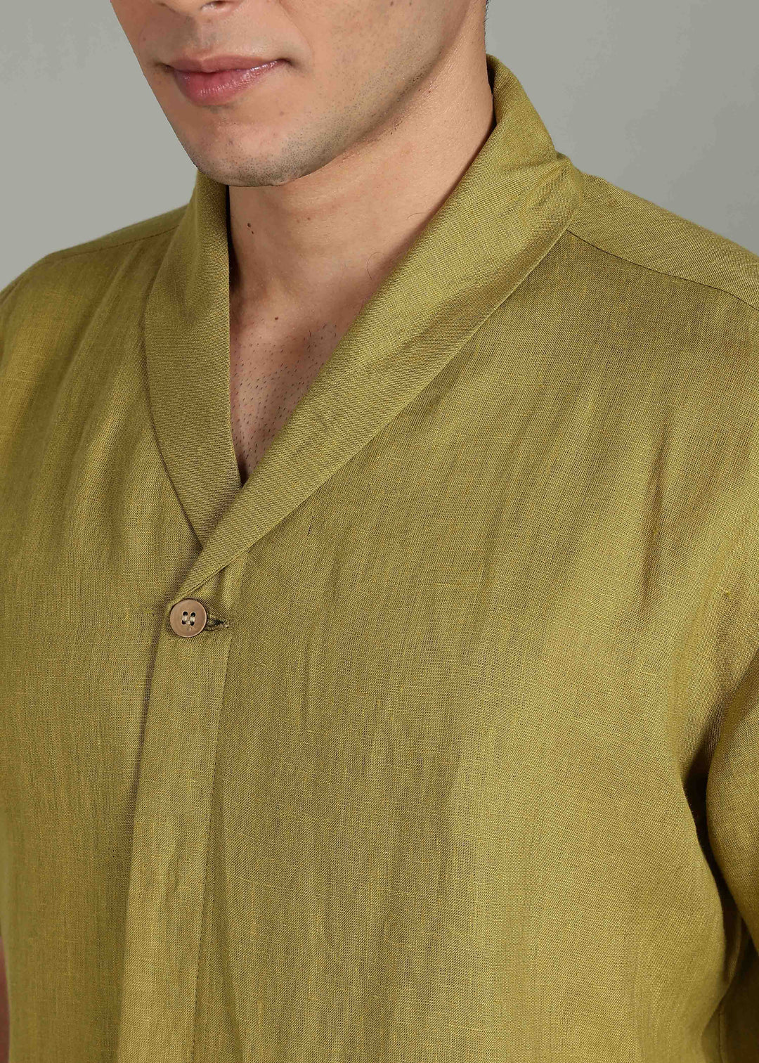 Man wearing 100% 60 LEA Sap Green Shawl collar Half sleeve Shirt in an indoor grey background.