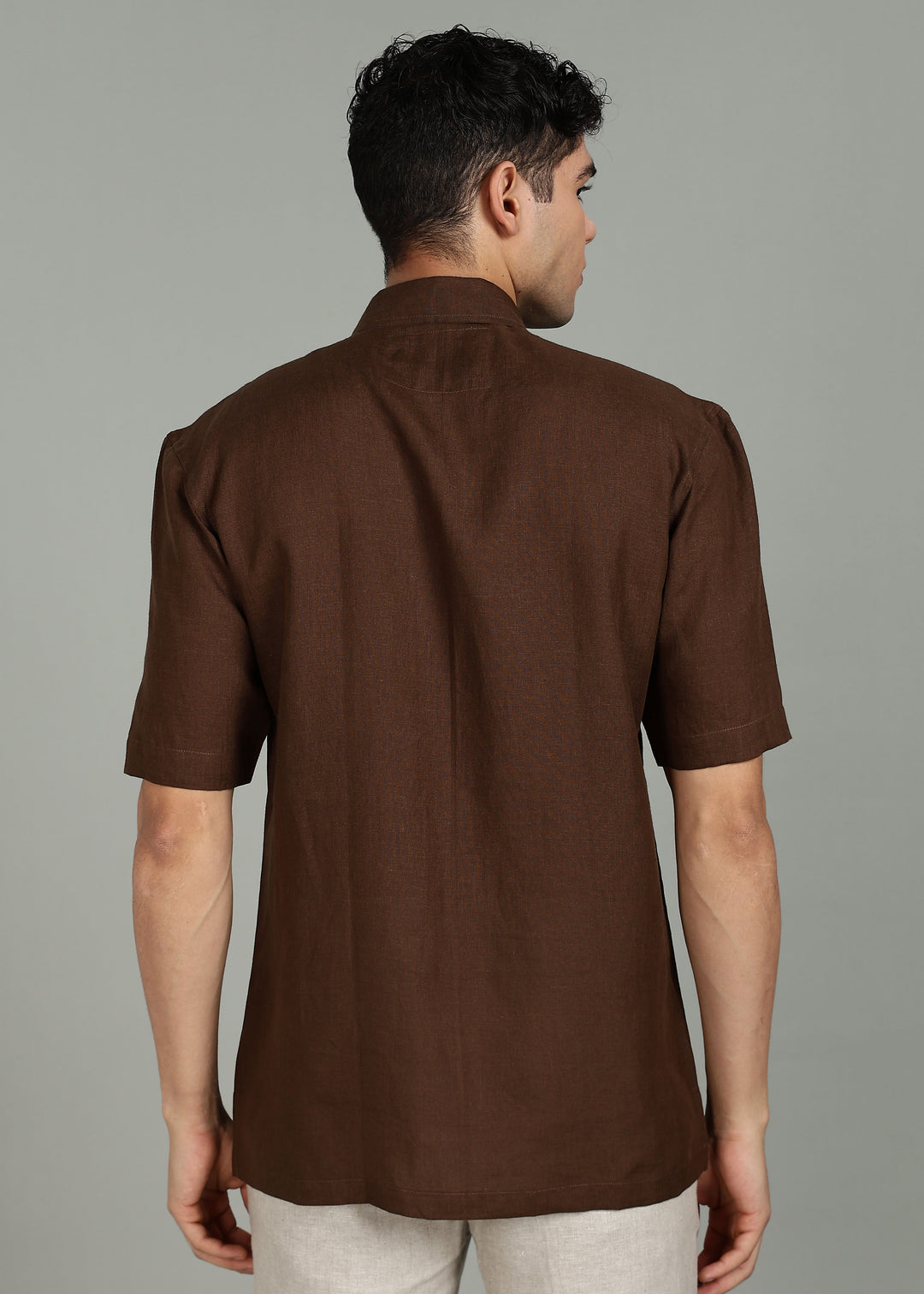 Man wearing 100% 60 LEA Coffee Brown Half sleeve Shirt in an indoor grey background.