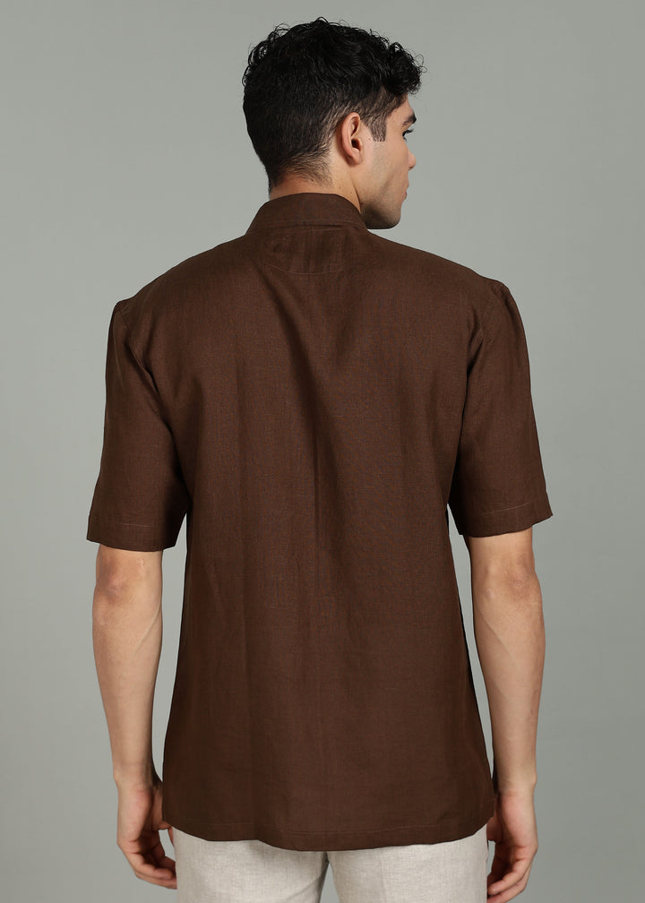 Man wearing 100% 60 LEA Coffee Brown Half sleeve Shirt in an indoor grey background.