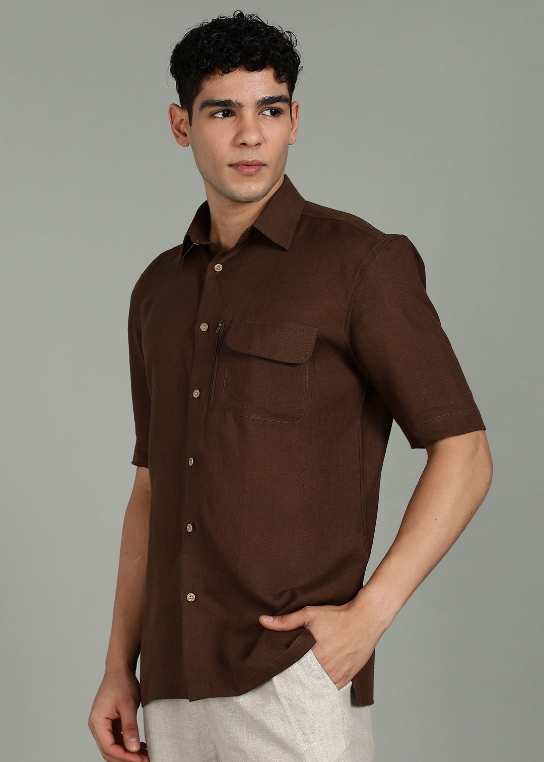 Man wearing 100% 60 LEA Coffee Brown Half sleeve Shirt in an indoor grey background.