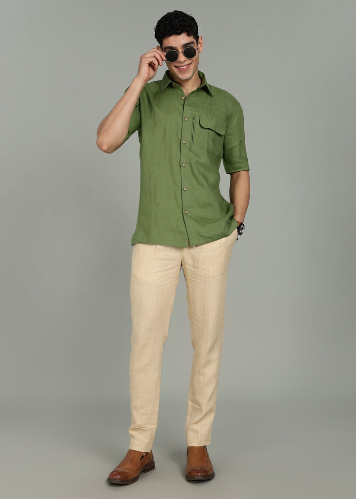Man wearing 100% 60 LEA Cossack Green Half sleeve Shirt in an indoor grey background.