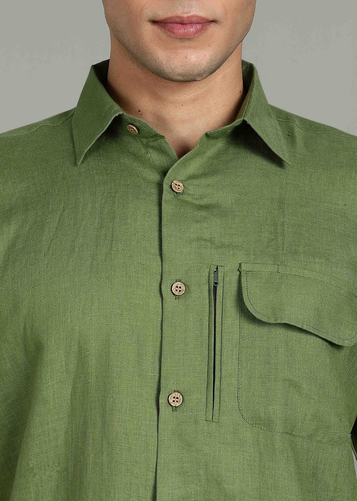 Man wearing 100% 60 LEA Cossack Green Half sleeve Shirt in an indoor grey background.