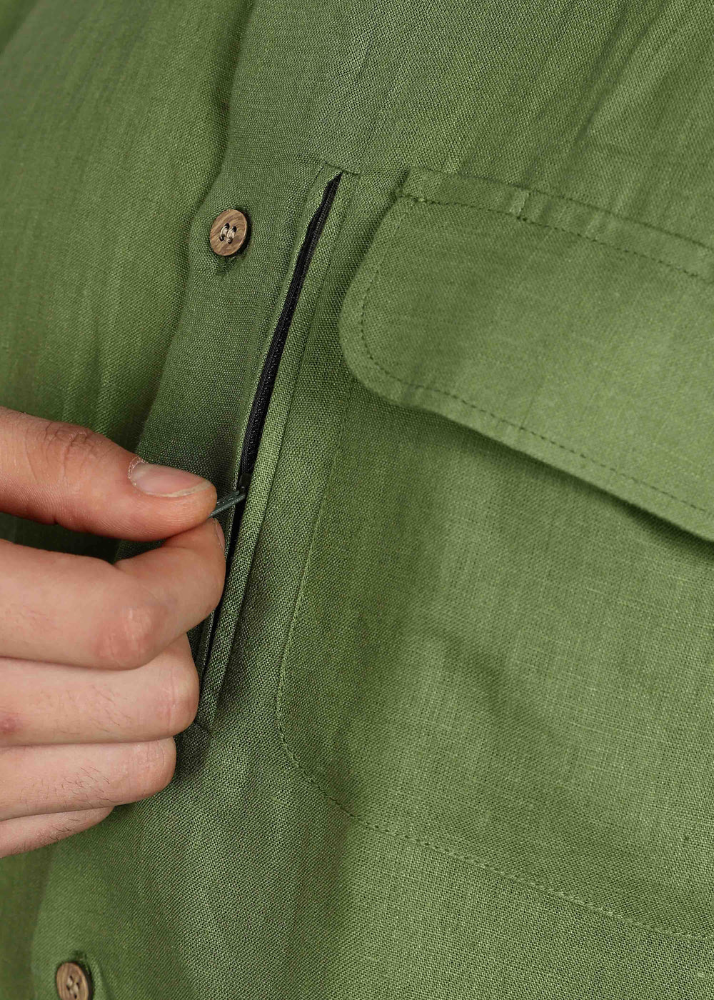 Man wearing 100% 60 LEA Cossack Green Half sleeve Shirt in an indoor grey background.