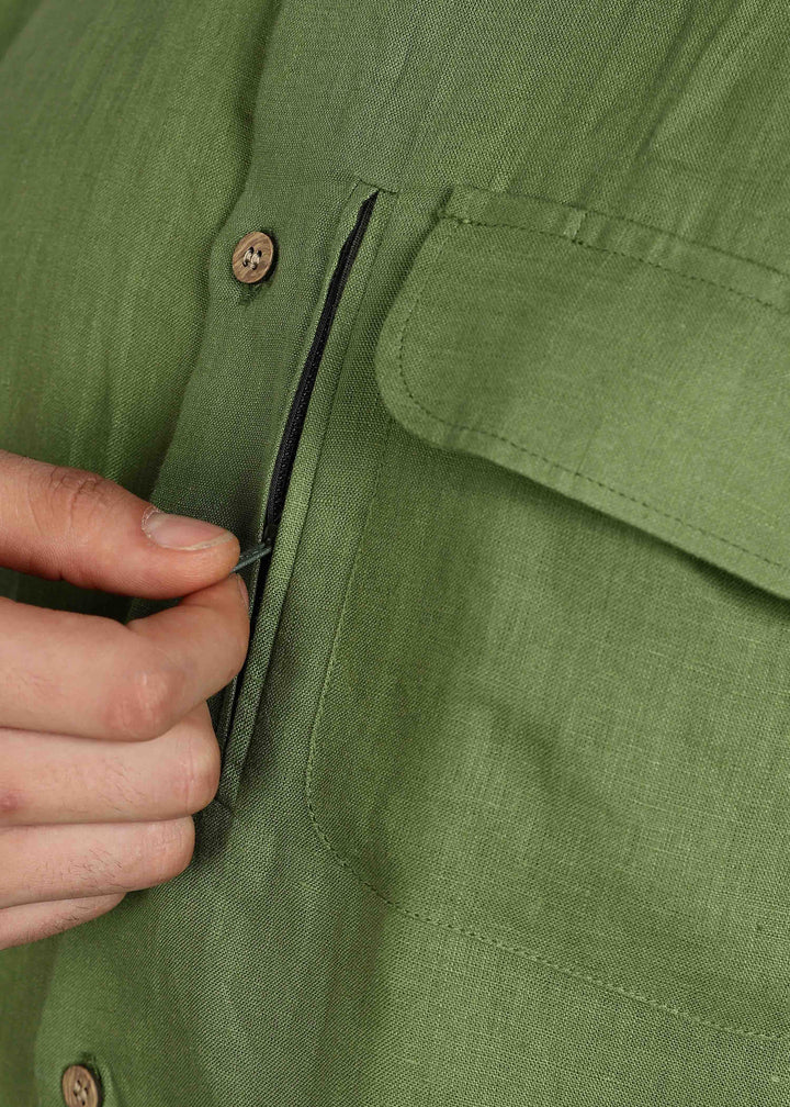 Man wearing 100% 60 LEA Cossack Green Half sleeve Shirt in an indoor grey background.