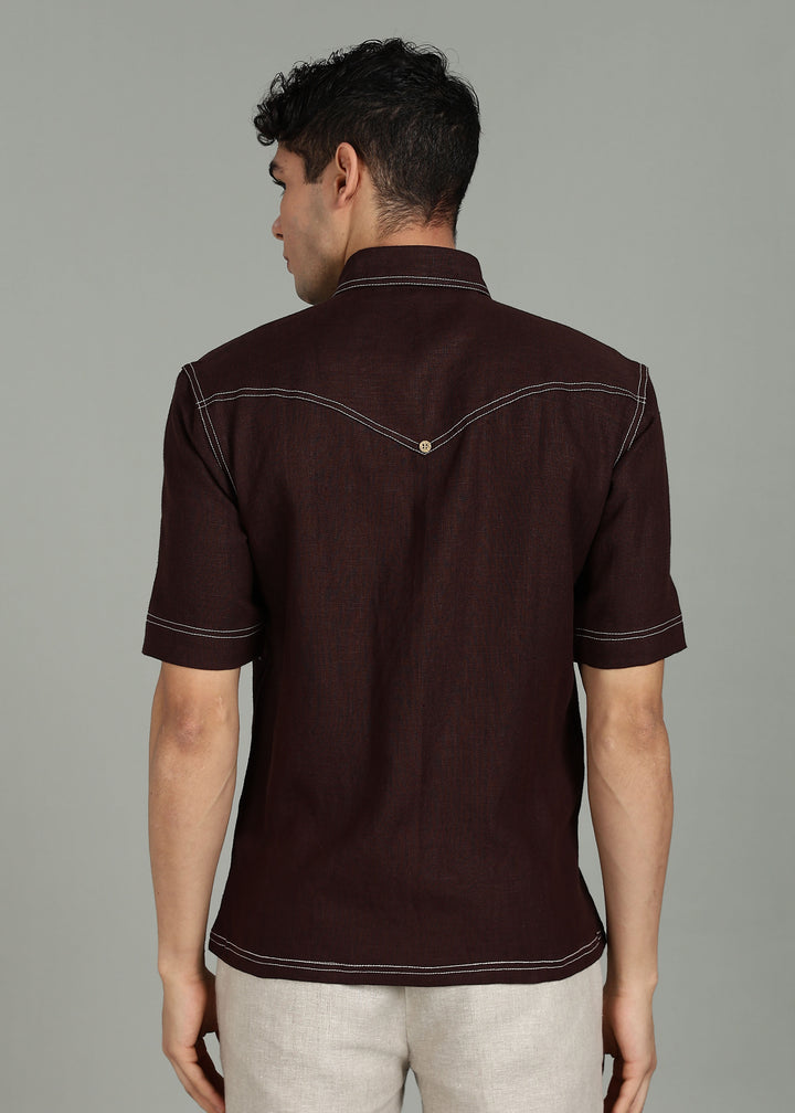 Man wearing 100% 25 LEA Cocoa Brown Half sleeve Shirt in an indoor grey background.