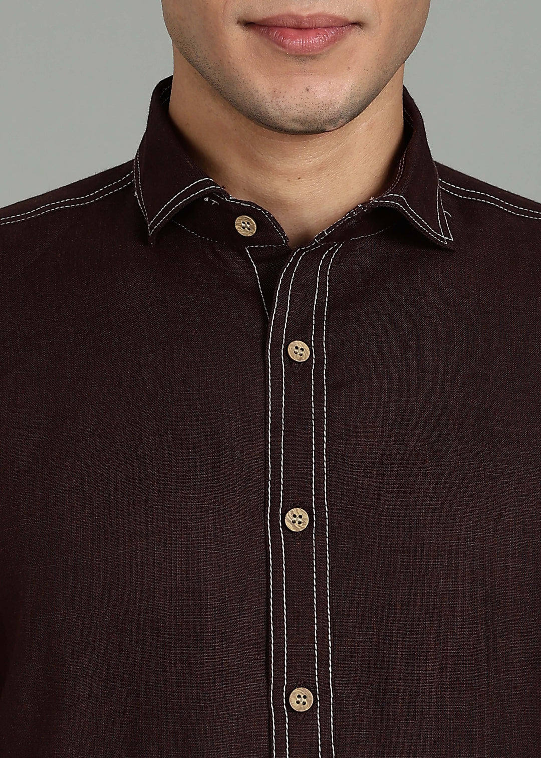 Man wearing 100% 25 LEA Cocoa Brown Half sleeve Shirt in an indoor grey background.