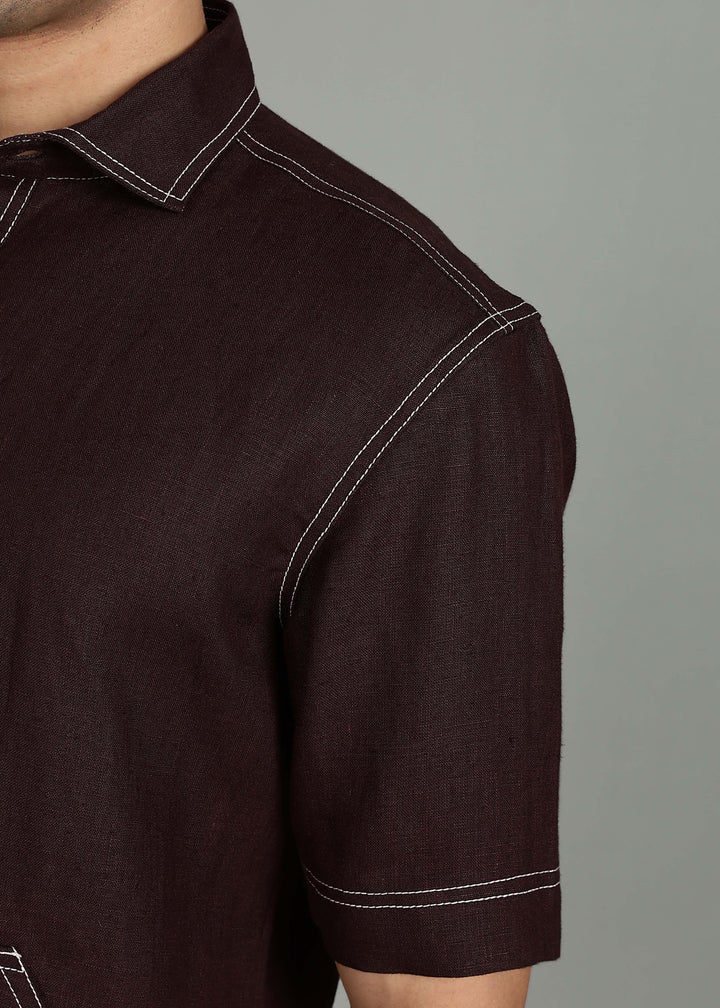 Man wearing 100% 25 LEA Cocoa Brown Half sleeve Shirt in an indoor grey background.