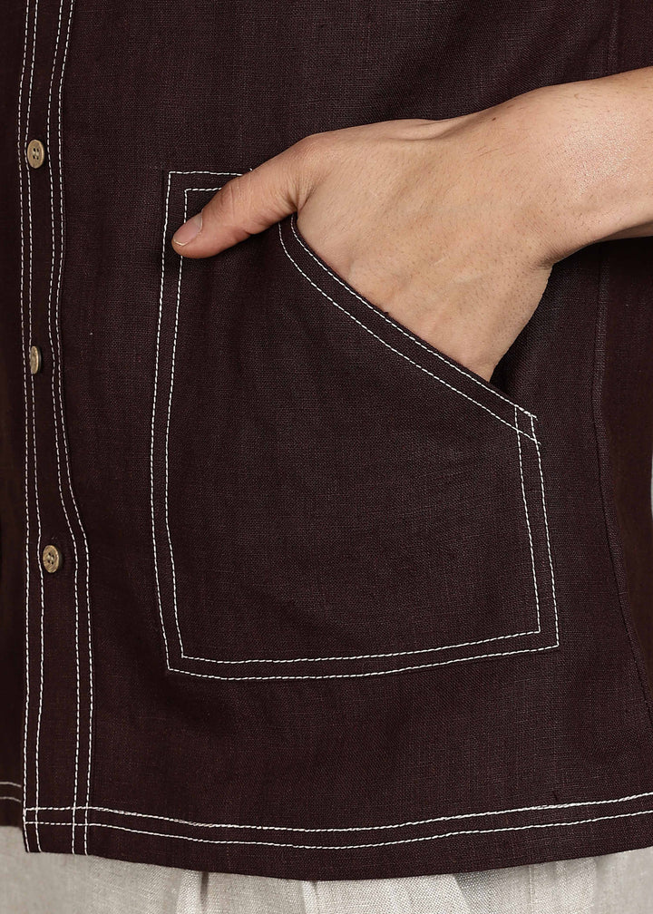 Man wearing 100% 25 LEA Cocoa Brown Half sleeve Shirt in an indoor grey background.