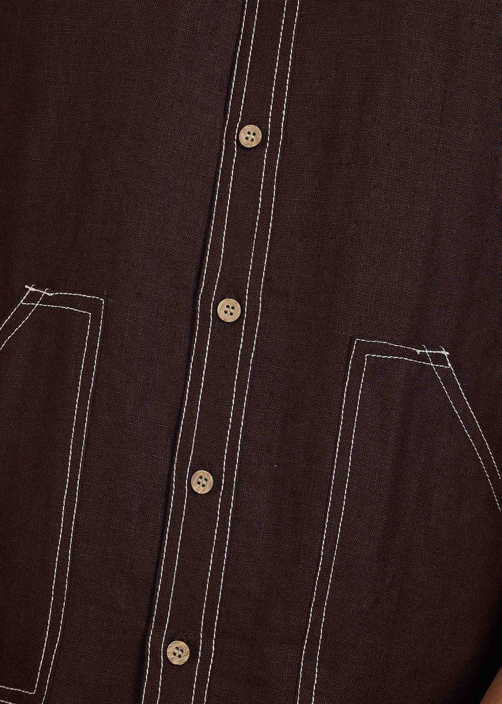 Man wearing 100% 25 LEA Cocoa Brown Half sleeve Shirt in an indoor grey background.