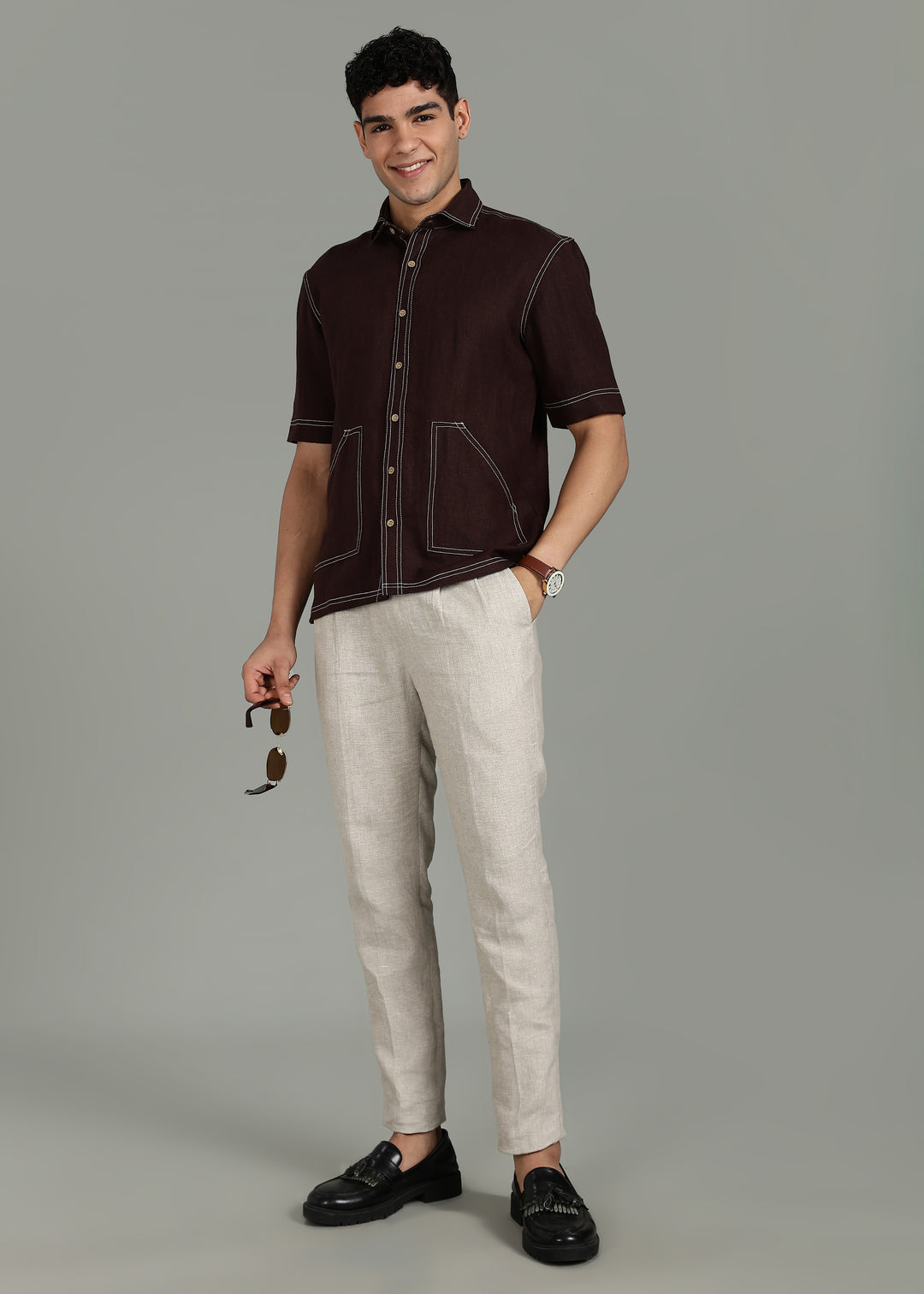 Man wearing 100% 25 LEA Cocoa Brown Half sleeve Shirt in an indoor grey background.