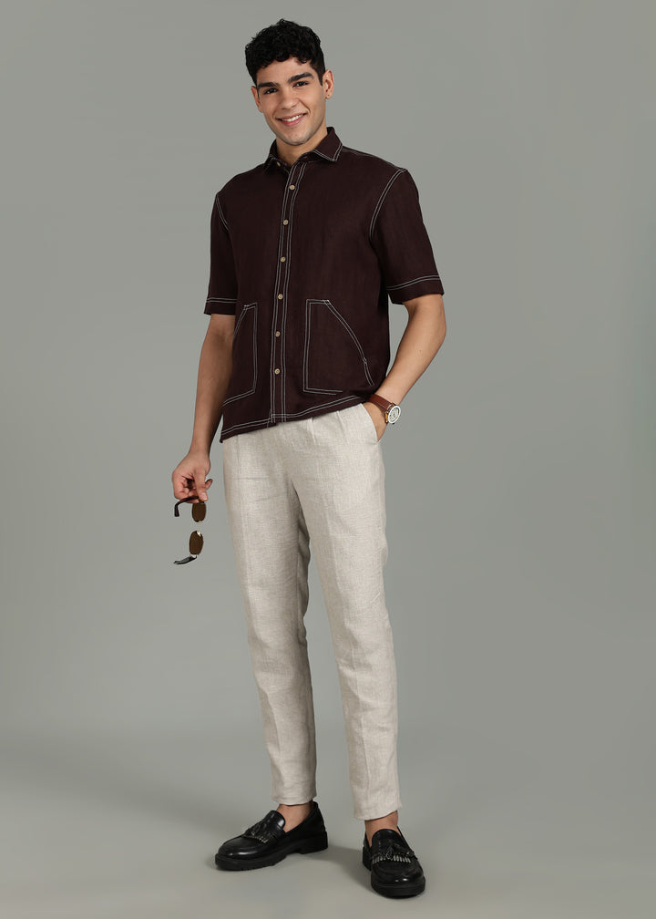 Man wearing 100% 25 LEA Cocoa Brown Half sleeve Shirt in an indoor grey background.