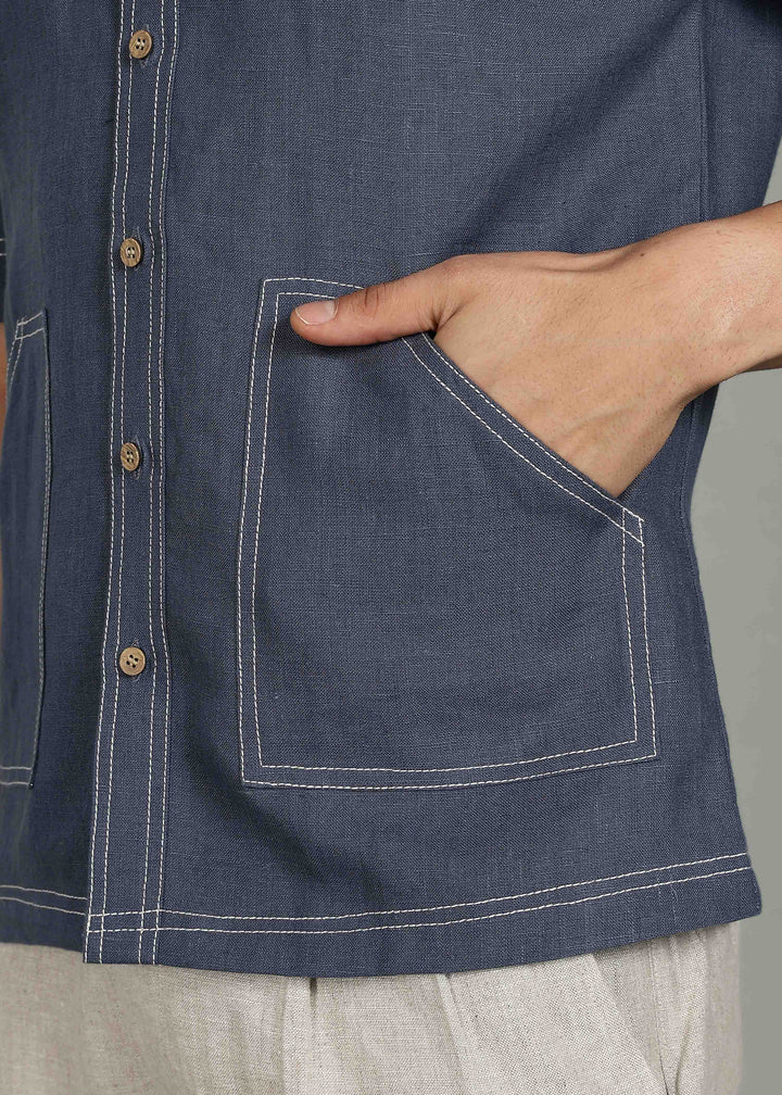 Man wearing 100% 25 LEA Dark Blue Grey Half sleeve Shirt in an indoor grey background.