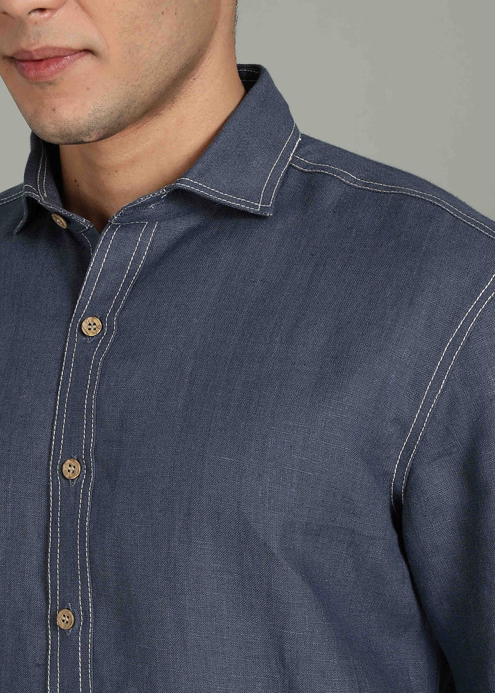 Man wearing 100% 25 LEA Dark Blue Grey Half sleeve Shirt in an indoor grey background.