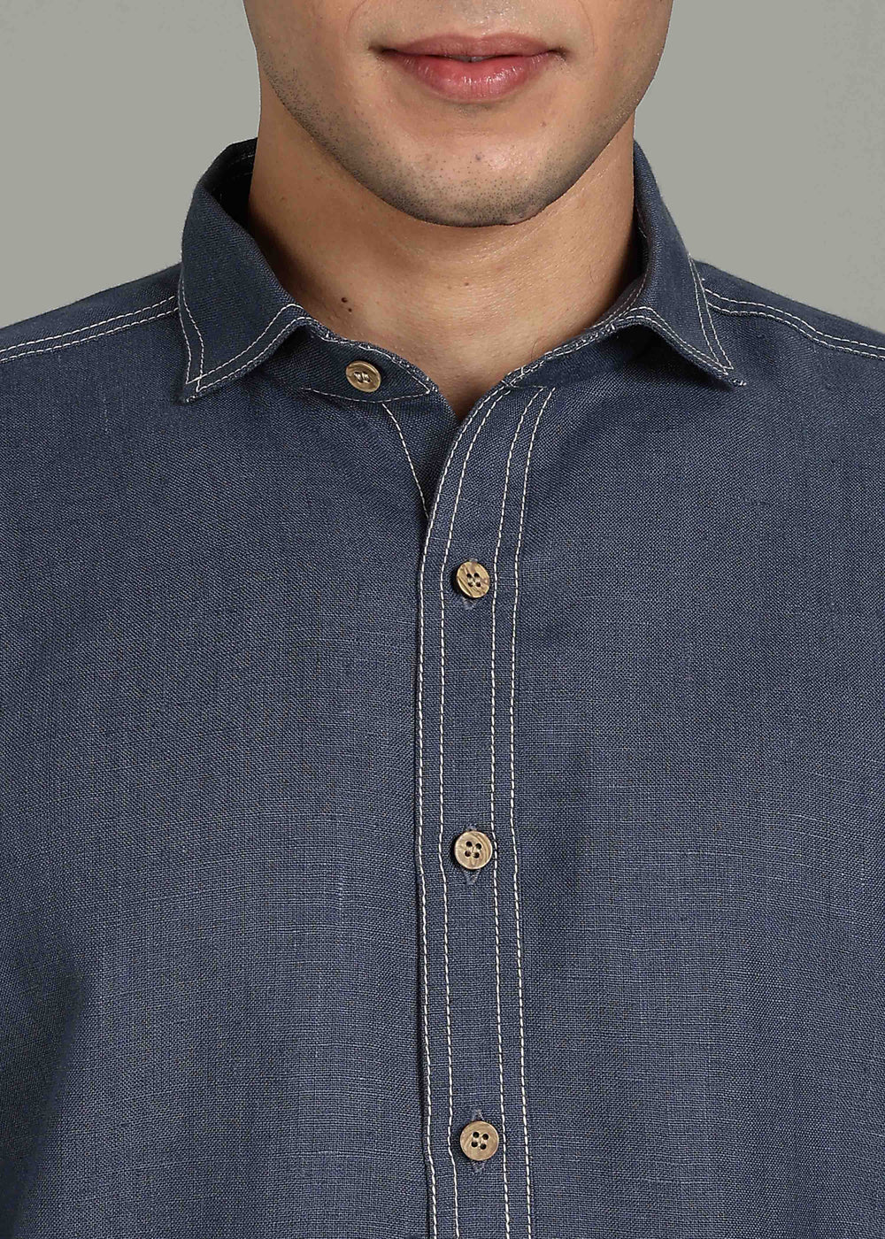 Man wearing 100% 25 LEA Dark Blue Grey Half sleeve Shirt in an indoor grey background.