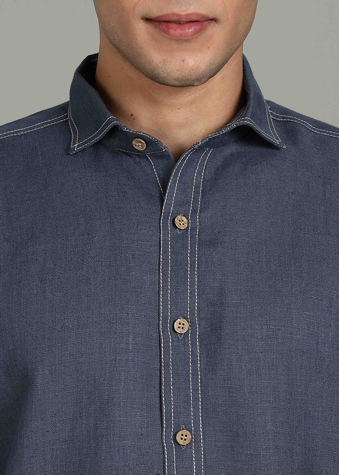 Man wearing 100% 25 LEA Dark Blue Grey Half sleeve Shirt in an indoor grey background.