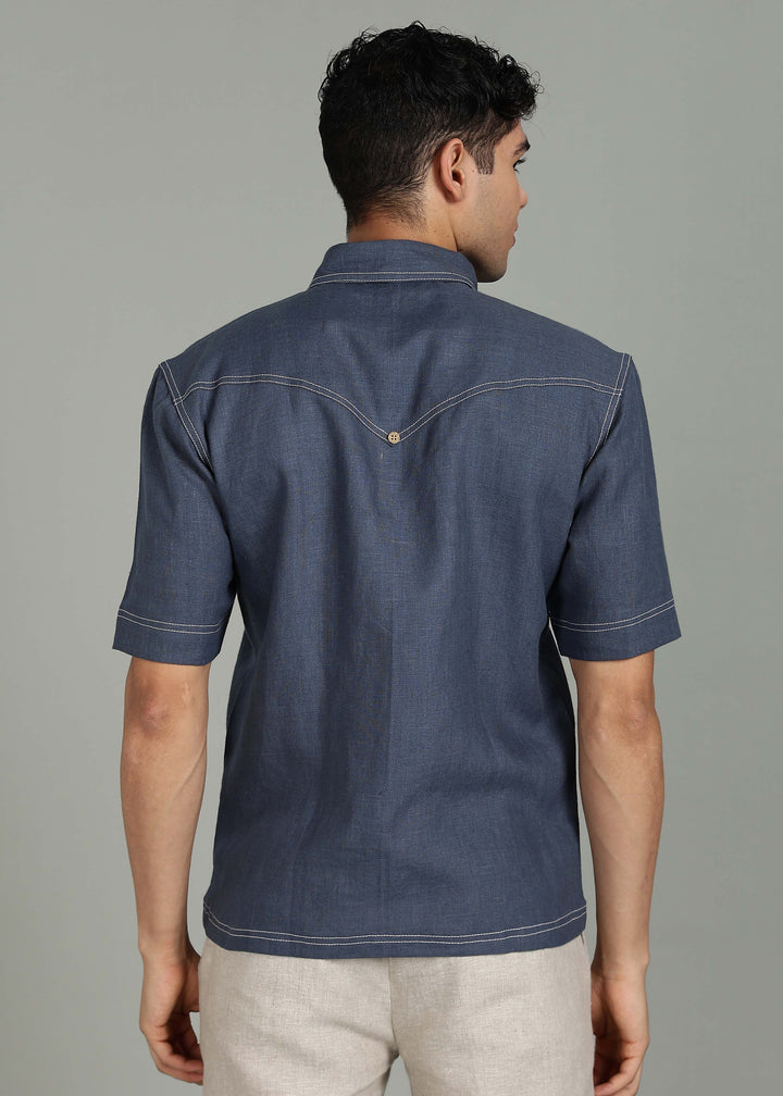 Man wearing 100% 25 LEA Dark Blue Grey Half sleeve Shirt in an indoor grey background.