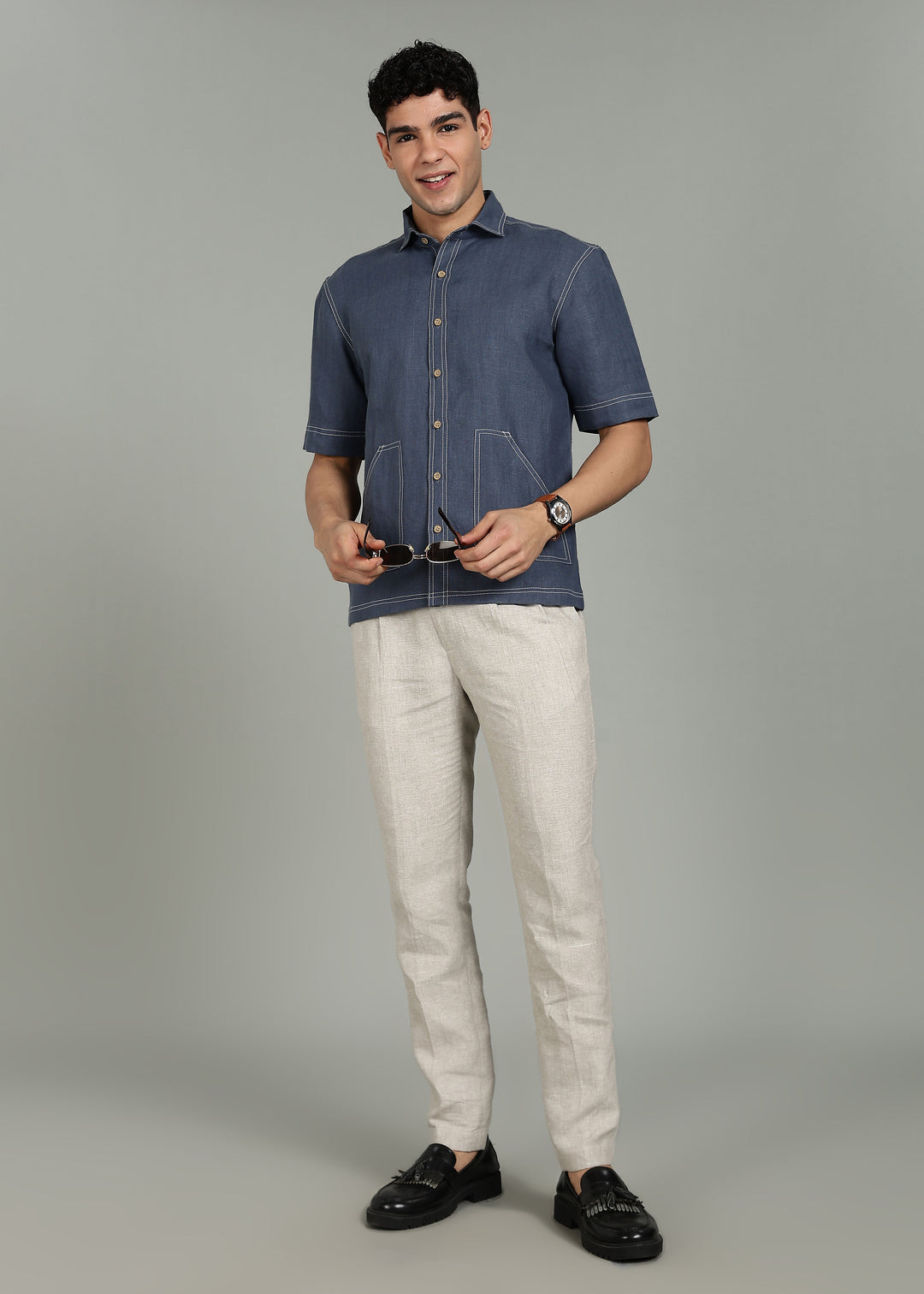 Man wearing 100% 25 LEA Dark Blue Grey Half sleeve Shirt in an indoor grey background.