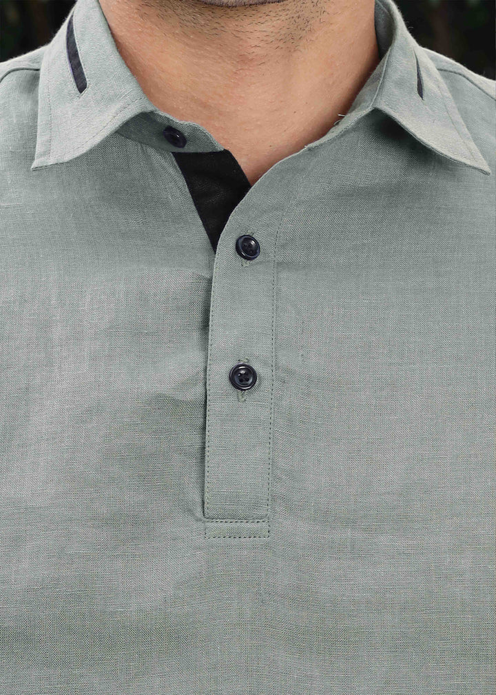 Close-up of a 100% pure linen gray t-shirt with black buttons on a blurred background