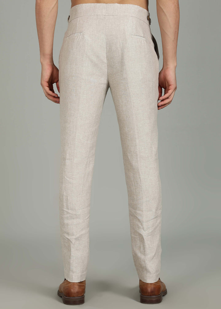 Man wearing 100% 25 LEA Ecru formal pants in an indoor grey background.