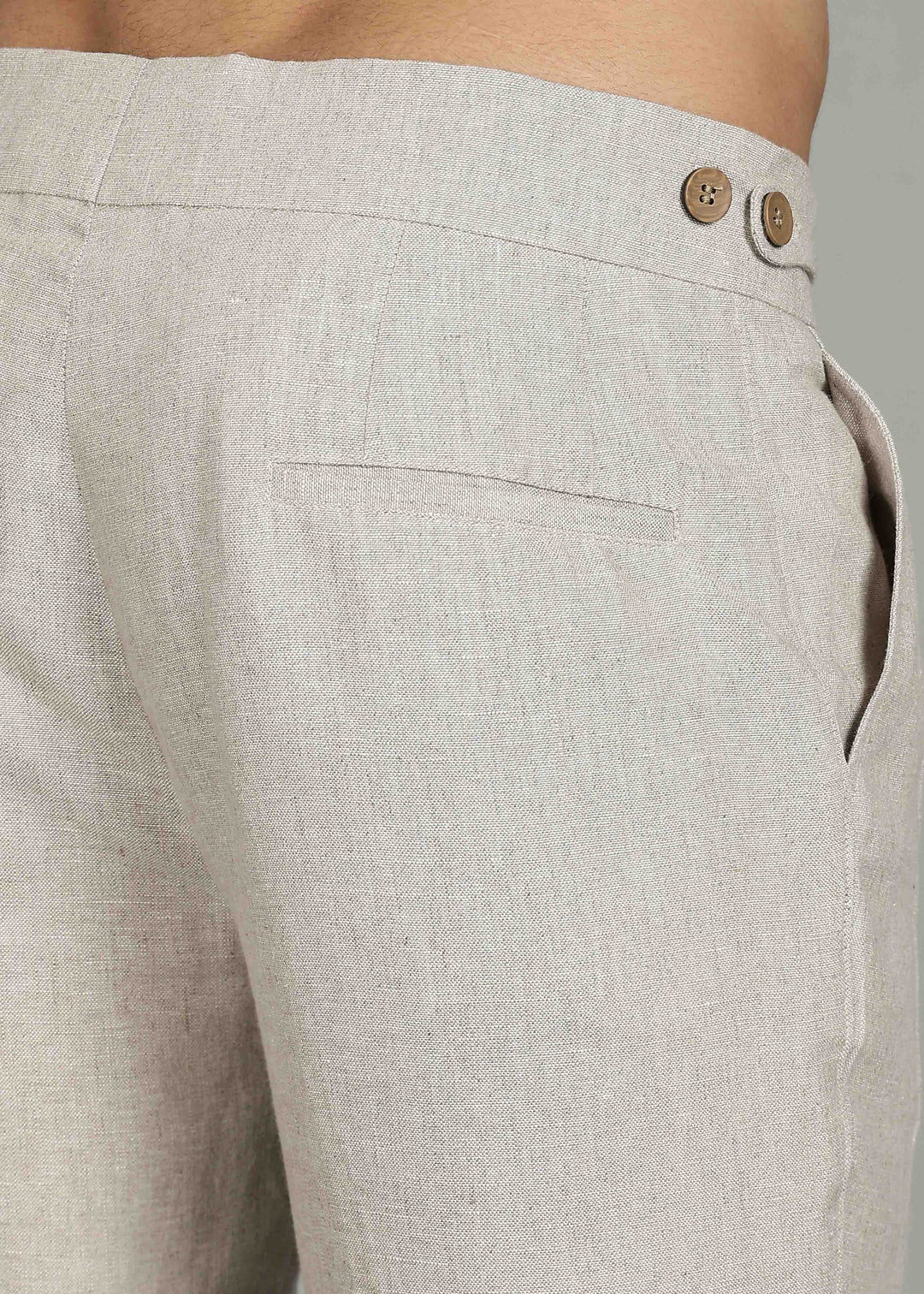 Man wearing 100% 25 LEA Ecru formal pants in an indoor grey background.