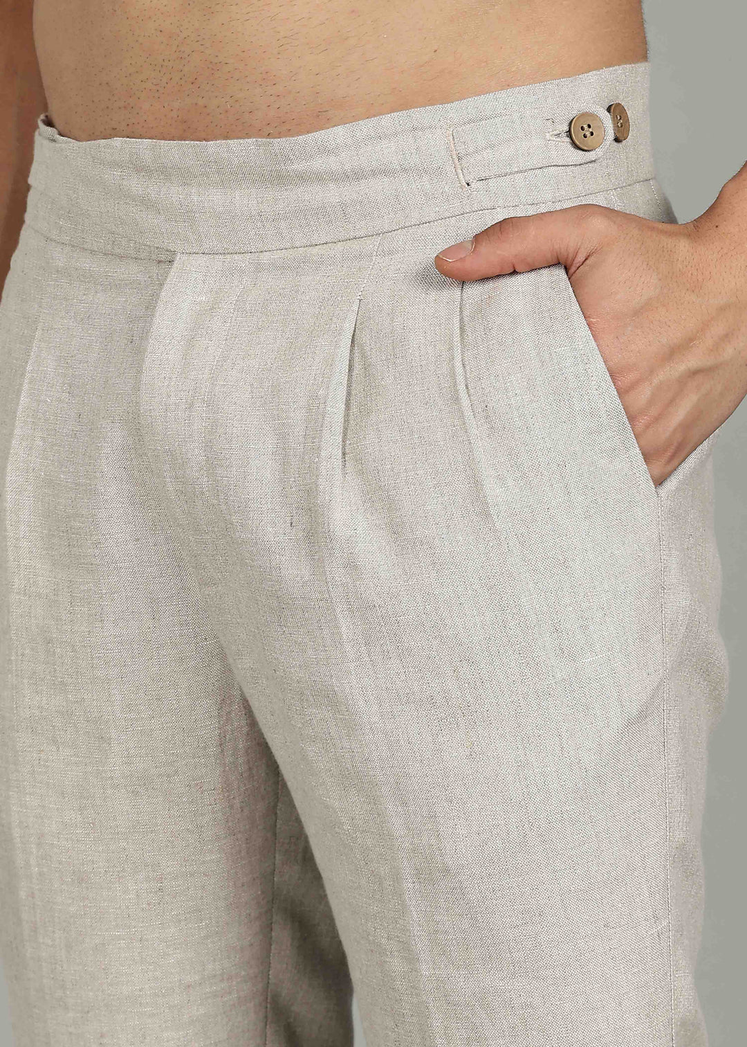 Man wearing 100% 25 LEA Ecru formal pants in an indoor grey background.