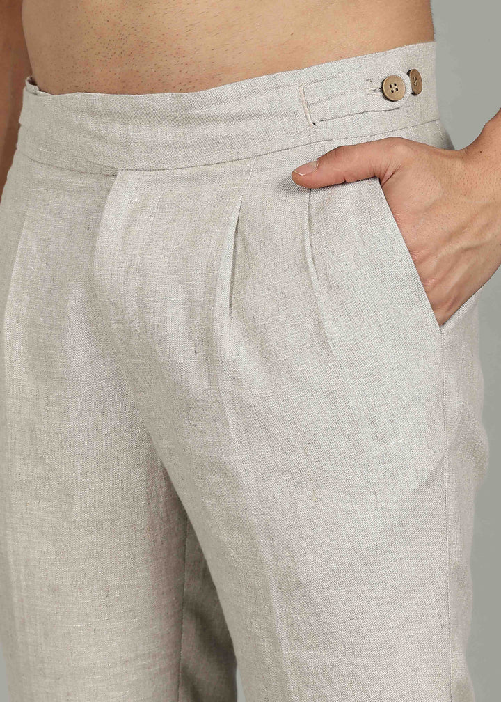 Man wearing 100% 25 LEA Ecru formal pants in an indoor grey background.