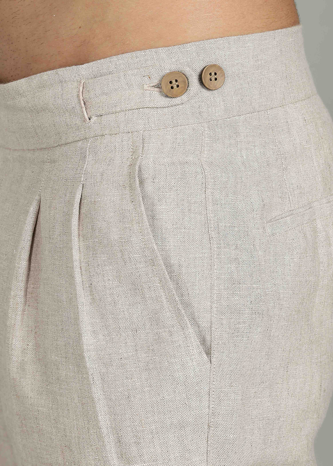 Man wearing 100% 25 LEA Ecru formal pants in an indoor grey background.