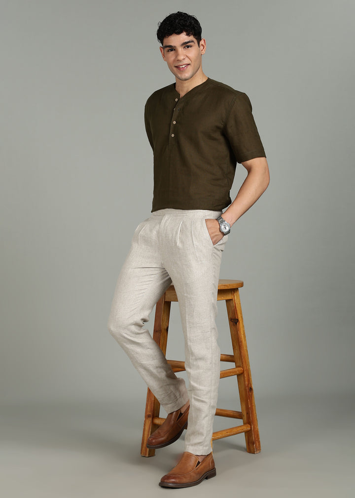 Man wearing 100% 25 LEA Ecru formal pants in an indoor grey background.