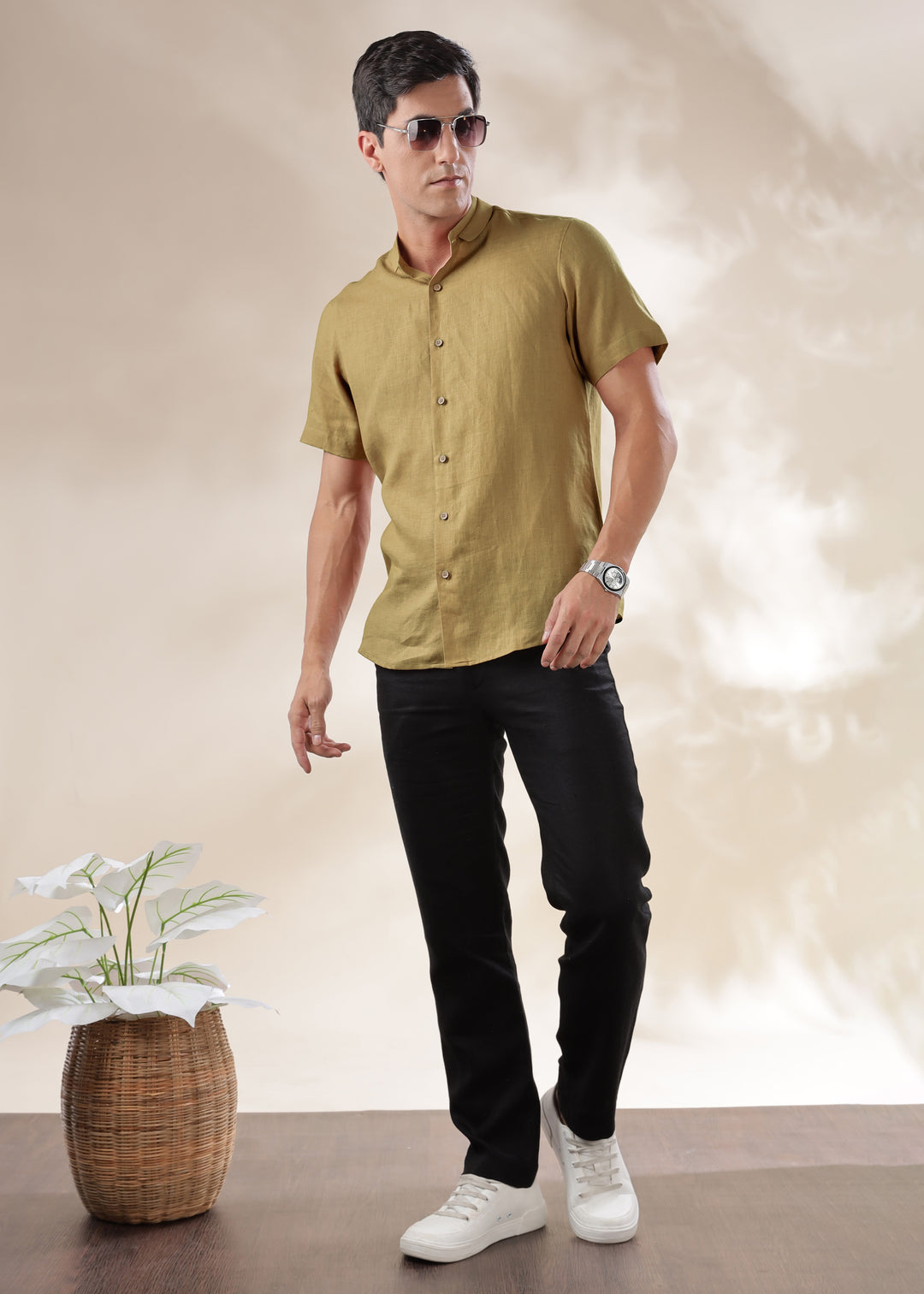 A man wearing a 100% pure linen 60 LEA sunburst yellow mandarin collar half sleeve shirt