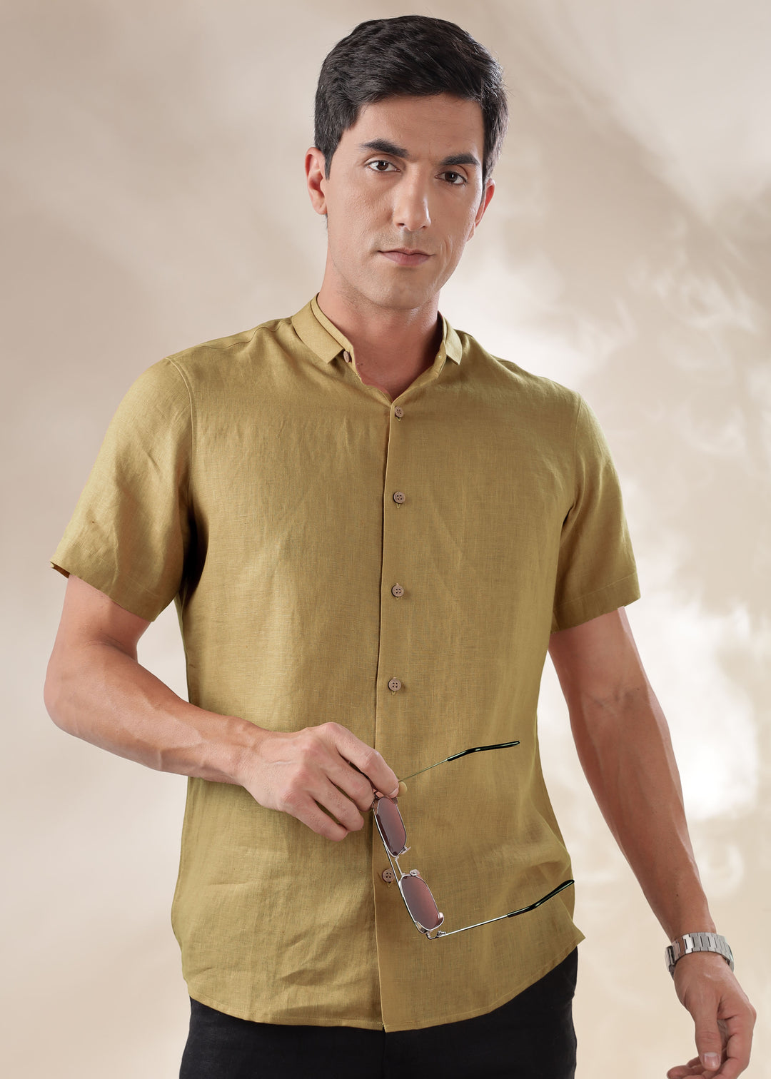 A man wearing a 100% pure linen 60 LEA sunburst yellow mandarin collar half sleeve shirt