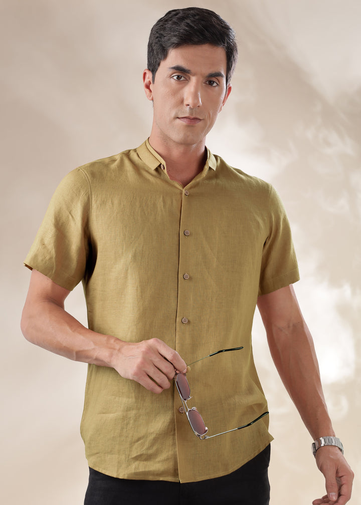 A man wearing a 100% pure linen 60 LEA sunburst yellow mandarin collar half sleeve shirt