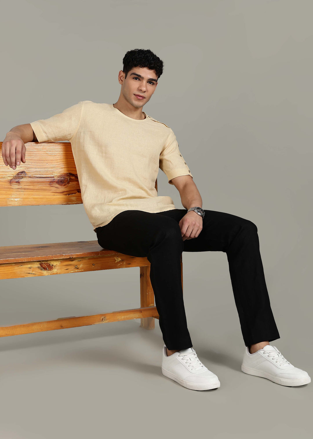 Man wearing 100% 60 LEA Light Tea Yellow Mandarin collar  T - Shirt in an indoor grey background.