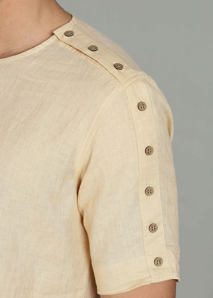 Man wearing 100% 60 LEA Light Tea Yellow Mandarin collar  T - Shirt in an indoor grey background.
